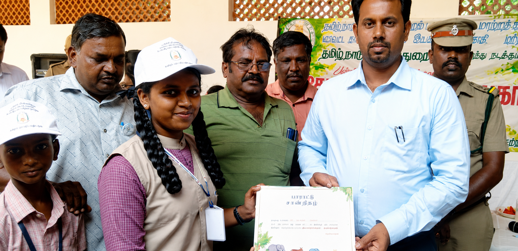 Sathana Vidyalaya student receiving a certificate